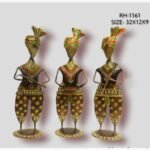 Handcrafted three-piece Rajasthani musicians iron sculpture set featuring hand-painted floral harem pants, colorful turbans, and traditional folk instruments on flat oval bases.