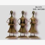 Handcrafted three-piece Rajasthani tribal women musicians iron sculpture set featuring hand-painted patterned chaniya choli skirts, traditional folk instruments, and rectangular bases.