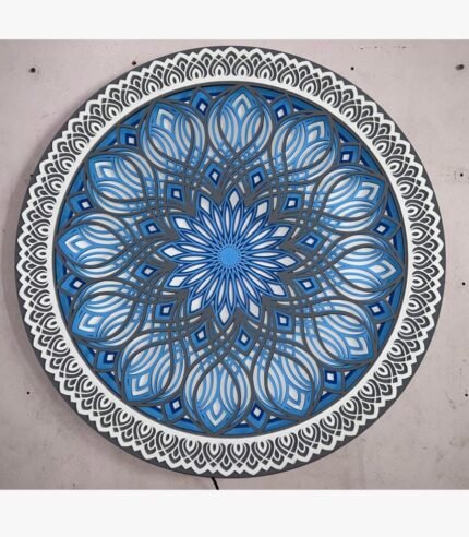 Handcrafted circular 3D layered wooden mandala panel titled Sapphire Resonance featuring intricate geometric laser-cut petals in gradient shades of blue, grey, and white.