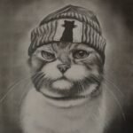 Original charcoal pencil sketch titled Feline Attitude by Sunny Devani depicting an expressive, grumpy cat wearing a knitted beanie hat with a cat silhouette patch.