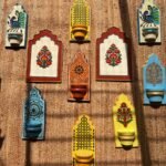 Hand-painted traditional Indian wooden Jharokha wall brackets with Lippan mirror work and Mughal floral motifs by artist Rucha Desai.