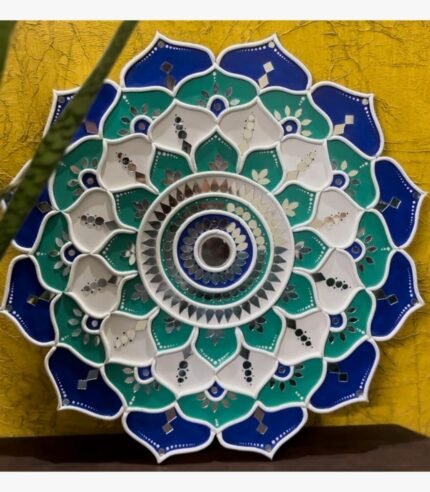 Handcrafted circular blooming lotus mandala Lippan wall art in blue, teal, and white with intricate mirror work by artist Rucha Desai.