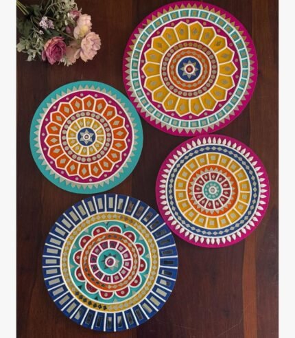 Handcrafted circular Lippan art wall plates set featuring vibrant mandala patterns and detailed mirror work by artist Rucha Desai.