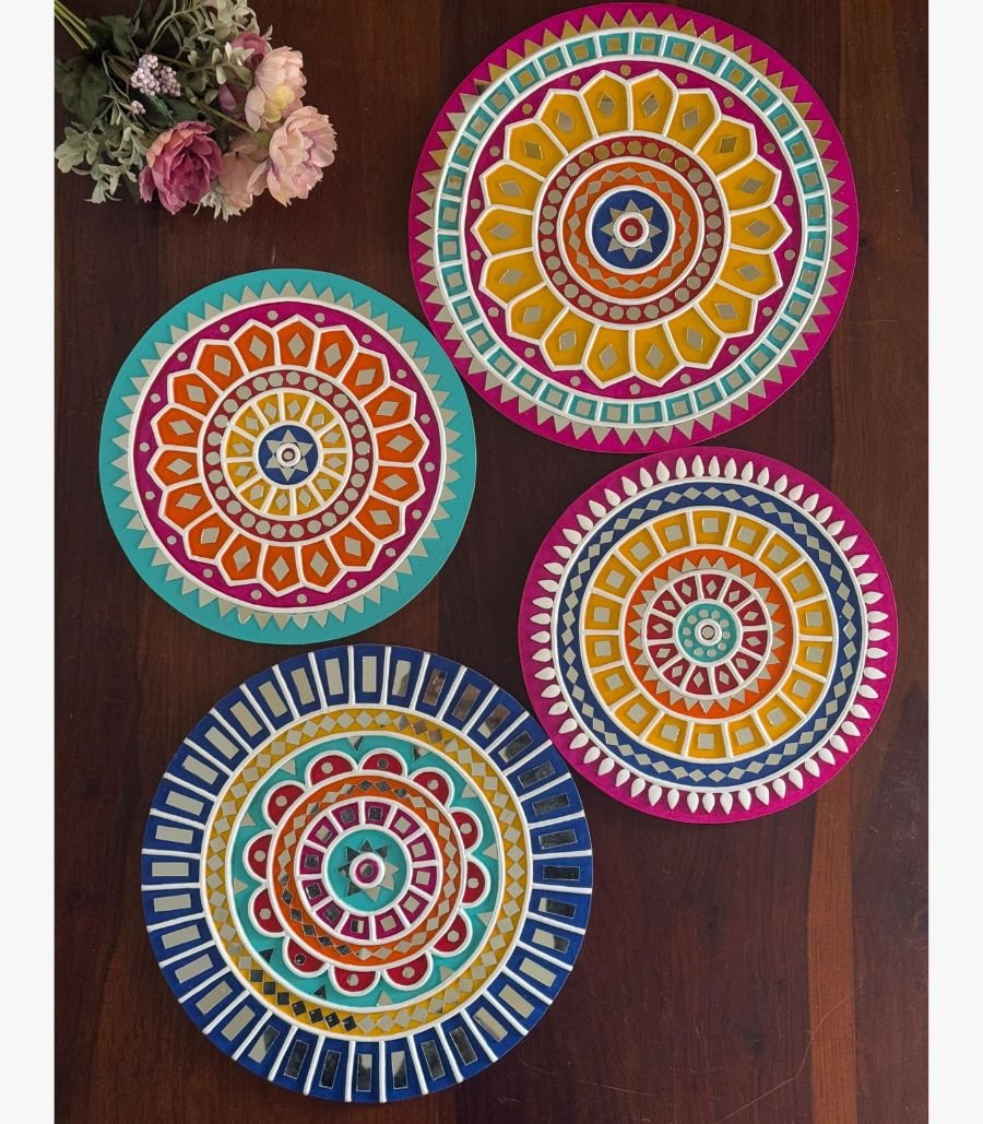 11 Handcrafted circular Lippan art wall plates set featuring vibrant mandala patterns and detailed mirror work by artist Rucha Desai.