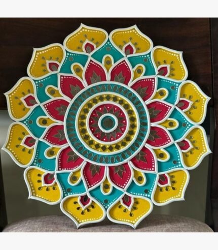 Handcrafted circular Lippan art wall hanging featuring yellow, turquoise, and crimson scalloped lotus mandala patterns with mirror work by artist Rucha Desai.