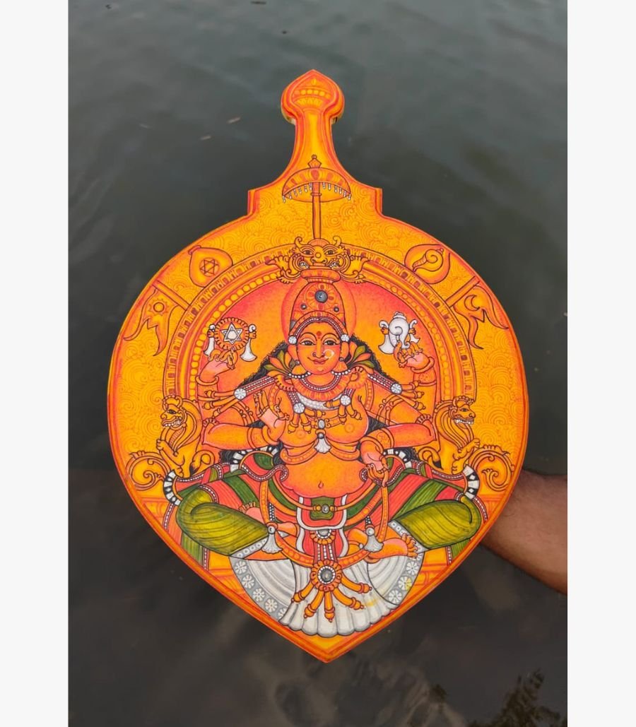 16 Traditional Kerala mural painting titled Goddess Bhagavathy by Akshaya Sivadas featuring a detailed portrait of the four-armed deity seated enthroned on a shaped wooden board.