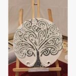 Handcrafted circular white Lippan clay art titled Tree of Life Serenity by Khushboo Gohel featuring an intricate sculpted tree mosaic embellished with reflective glass mirror tiles on a wooden canvas display.