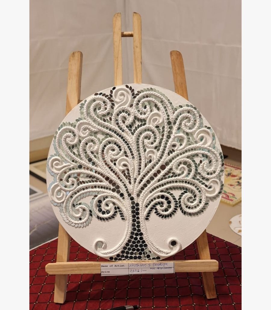 2 Handcrafted circular white Lippan clay art titled Tree of Life Serenity by Khushboo Gohel featuring an intricate sculpted tree mosaic embellished with reflective glass mirror tiles on a wooden canvas display.
