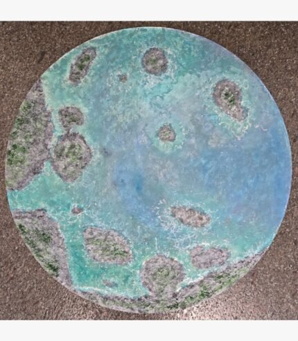 An original round circular aerial ocean artwork on canvas featuring turquoise water, foaming waves, and rocky islands by artist Jyoti Machigad.