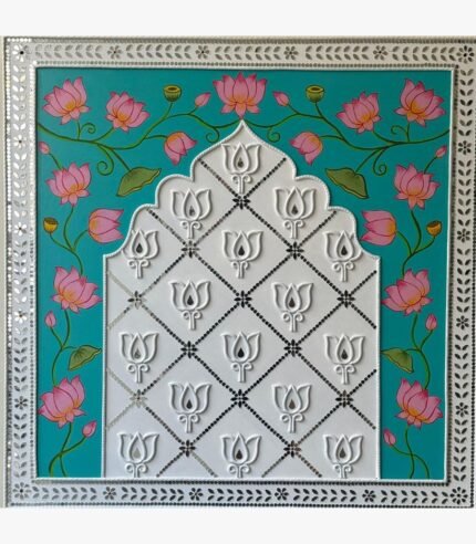 An original square traditional Indian artwork featuring hand-painted pink lotus vines and a central white Lippan clay Jharokha arch with mirror work by artist Rucha Desai.