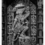 Highly detailed monochrome charcoal and graphite sketch titled Lord Varaha Avatar by Bharti Parmar depicting the stone relief carving of Vishnu's boar incarnation within an ancient temple frame.