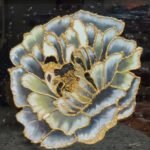 Handcrafted contemporary glass painting titled Golden Peony Bloom by Sabana Munshi featuring a layered grey and white peony flower outlined with metallic gold textured borders on a dark background.