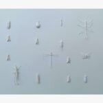 A minimalist monochromatic white mixed media paper relief sculpture featuring an assortment of meticulously detailed insect figures mounted across a textured pale off-white background by Hardev Chauhan.