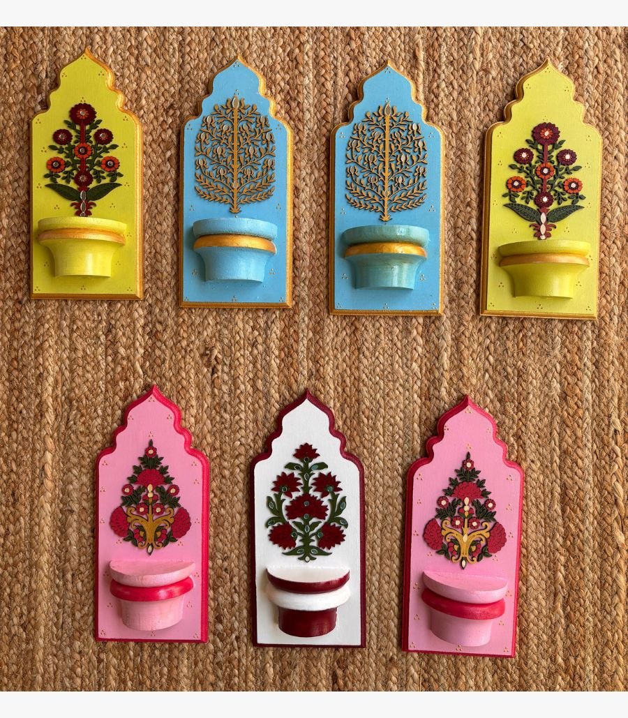4 Handcrafted wooden royal jharokha wall brackets with floral motifs in pastel yellow, sky blue, pink, and white painted by artist Rucha Desai.