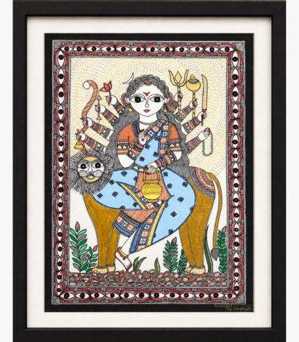 A traditional Madhubani painting on handmade paper depicting eight-armed Goddess Kushmanda in a blue patterned sari seated on a lion holding a sacred water pot, bow, arrow, lotus, and trident, framed by a protective eye-pattern border by artist Anupriya.