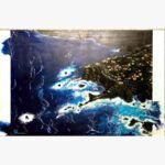 An original aerial seascape canvas painting featuring dark blue ocean waves crashing against Mediterranean coastal cliffs by artist Jyoti Machigad.