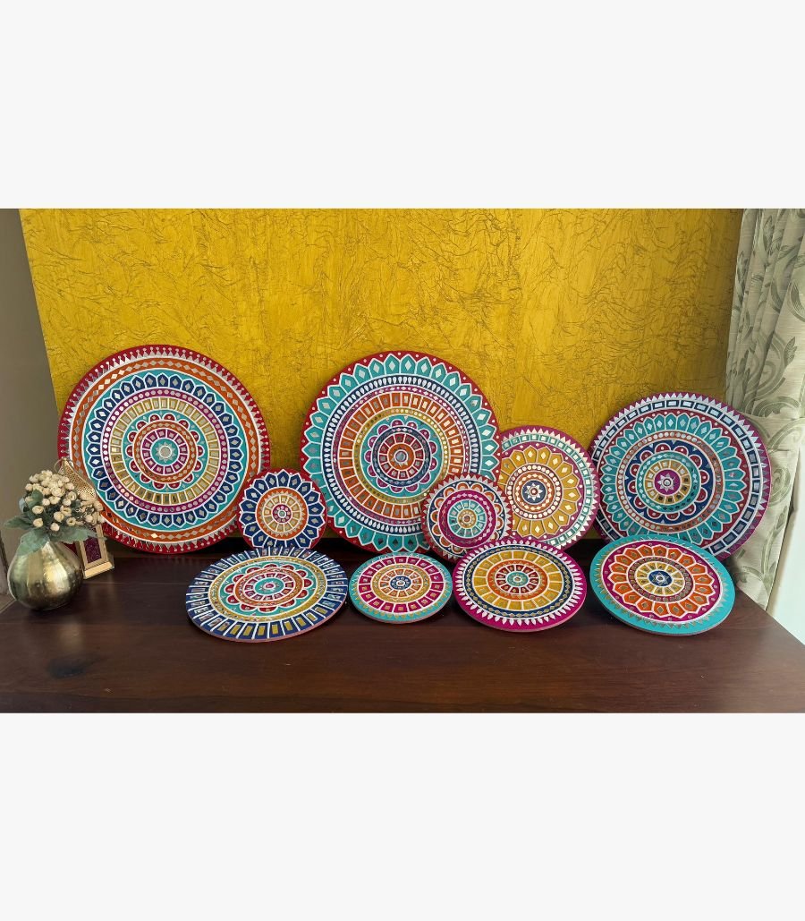 5 Handcrafted multi-colored Lippan art wall plates set with detailed mandala patterns and mirror work by artist Rucha Desai.