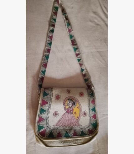 A hand-painted Madhubani folk art fabric sling bag featuring a traditional Indian woman motif and geometric borders by artist Bhavna Mishra.
