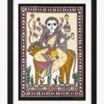 A traditional Madhubani painting on handmade paper depicting ten-armed Goddess Chandraghanta in a cream and red floral sari seated on a striped tiger mount, framed by a protective eye-pattern border by artist Anupriya.