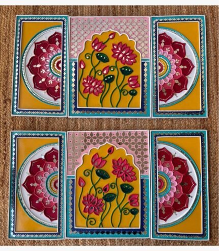 Handcrafted pair of blooming lotus arch Lippan art triptych sets featuring vibrant yellow and pink mud relief with mirror work by artist Rucha Desai.