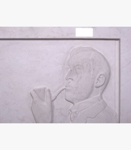 Hand-carved white marble bas-relief sculpture titled The Pipe Smoker by Julian Vance depicting a side profile portrait of a man holding and smoking a classic tobacco pipe.