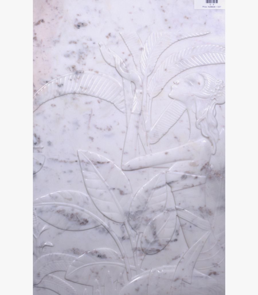 c Hand-carved white marble bas-relief sculpture titled Lady with Banana Tree by Mangalya Stone Panels depicting an elegant woman standing amidst tropical banana leaves and foliage.