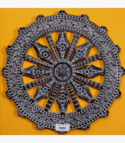 Hand-carved black stone relief wheel panel titled Dhammachakka Black Stone by Mangalya Stone Panels showcasing an intricate Dharma wheel with detailed decorative spokes and an ornate border.