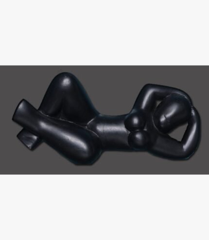 Hand-carved black stone minimalist sculpture titled Reclining Lady by Mangalya Stone Panels showcasing a stylized recumbent female figure with smooth contours.