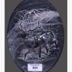 Hand-carved Abu-Black stone oval relief panel titled Chinkara by Mangalya Stone Panels showcasing a stag with large antlers moving against a mountainous landscape backdrop.