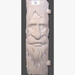 Hand-carved Gwalior white sandstone vertical relief panel titled Old Man Trunk by Mangalya Stone Panels showcasing a whimsical green man face carved to look like a weathered tree trunk.