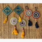 Handcrafted Indian Shubh Labh festive Lippan art wall hanging set featuring teal diamond plaques, colorful mirror medallions, and decorative tassels by Rucha Desai.