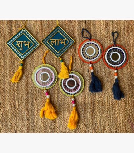 Handcrafted Indian Shubh Labh festive Lippan art wall hanging set featuring teal diamond plaques, colorful mirror medallions, and decorative tassels by Rucha Desai.