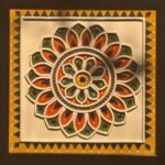 Handcrafted square lotus mandala Lippan art wall panel featuring clay relief work in orange, green, and yellow with glass mirror inlays framed in dark wood by Rucha Desai.