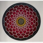 Handcrafted circular crimson lotus mandala Lippan art wall hanging featuring white clay relief work, mustard yellow center, and mirror inlays by Rucha Desai.