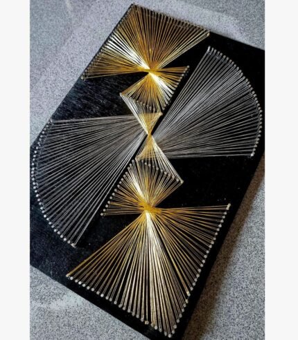 Modern 3D geometric string art featuring gold and silver thread fans on a textured black wooden board by Art Impression.