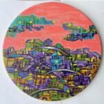 Circular acrylic canvas painting titled The Warmth of Cityscape by Payal Dubey depicting stylized buildings under a warm pink sky.